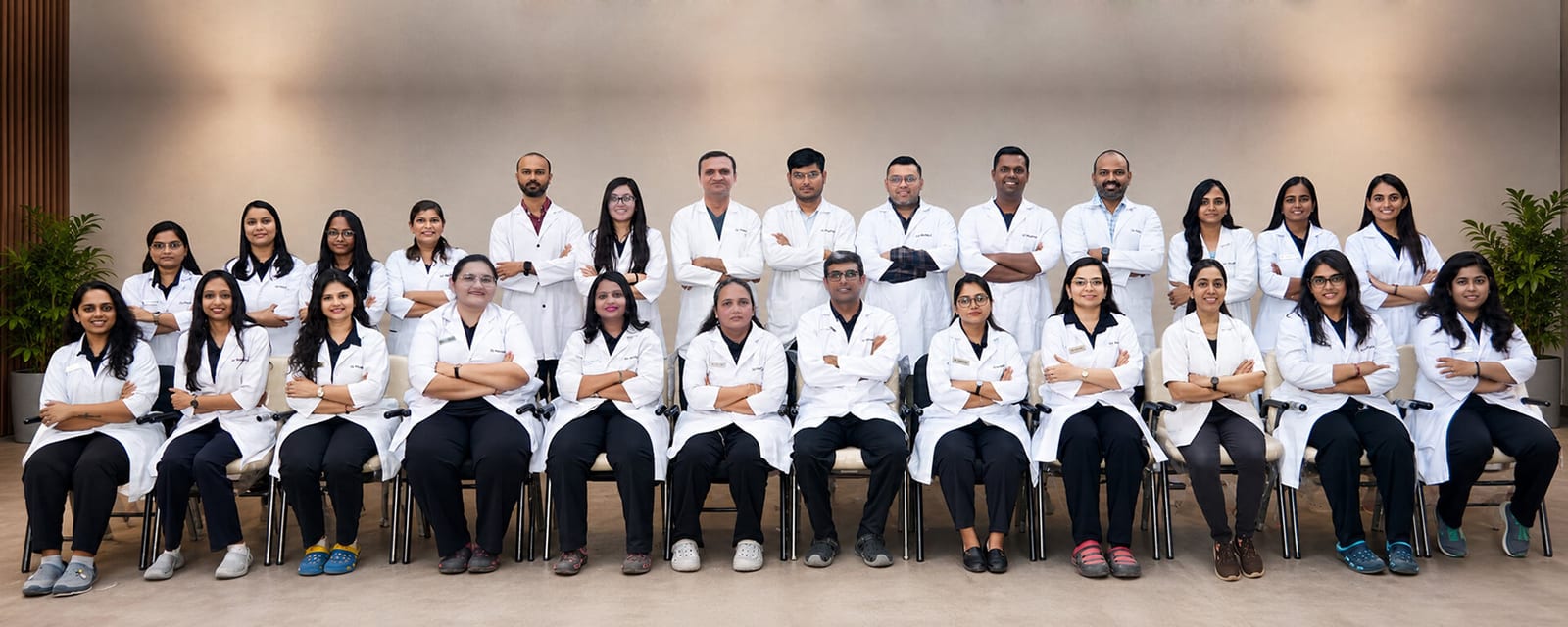 The 32 PEARLS team of doctors and staff in white coats